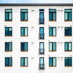 House keys and a stack of cash symbolizing rental income covering mortgage payments.