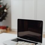 A person analyzing side hustle income and expenses on a laptop.