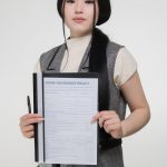A person reviewing disability insurance documents at a desk.