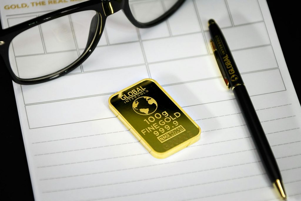 An illustration comparing gold bars and a stock market graph for wealth building.