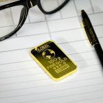 An illustration comparing gold bars and a stock market graph for wealth building.