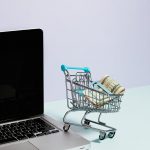 Person typing on laptop to monetize website and replace salary.