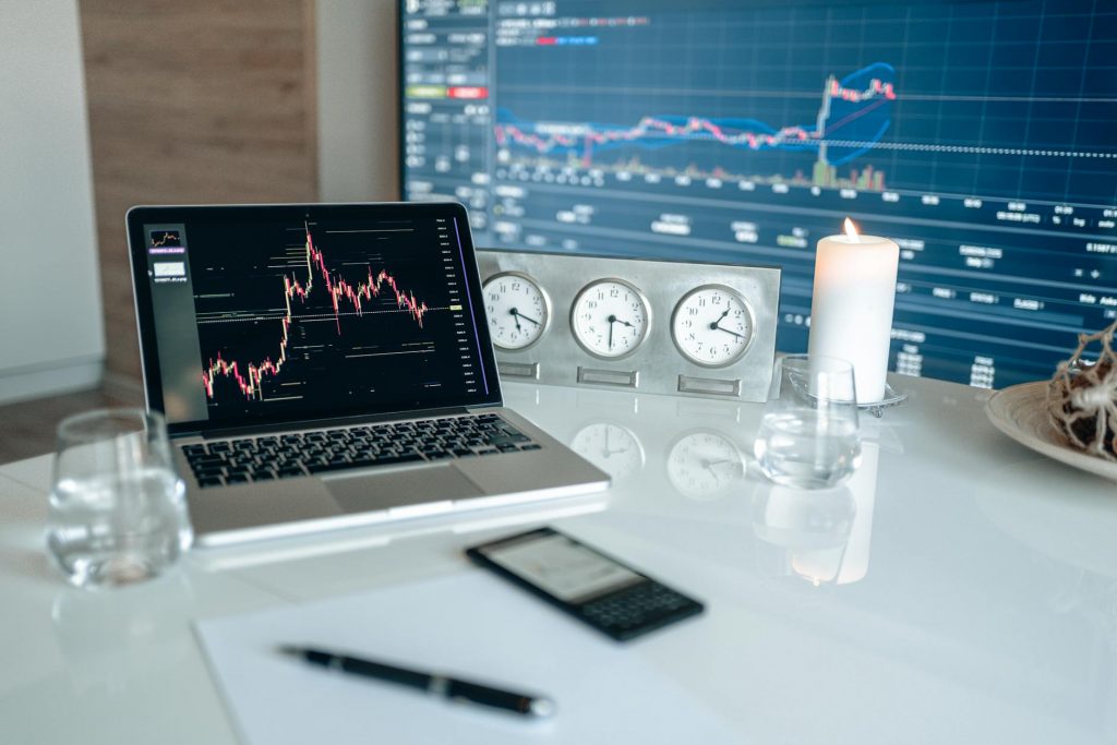 A person analyzing financial charts on a laptop, contemplating day trading for a living.